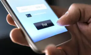 Mobile payment with wallet app and wireless nfc technology. Man paying and shopping with smartphone application and credit card information.